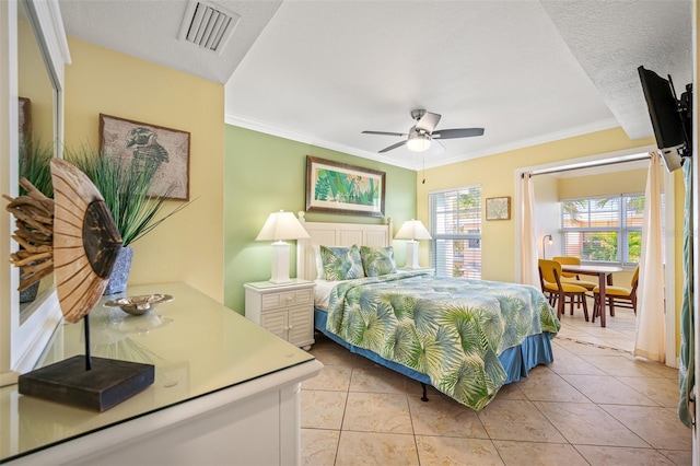 tiled bedroom featuring a textured ceiling, ceiling fan, and ornamental molding