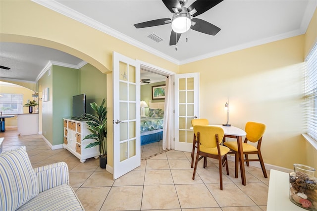 dining room featuring french doors, light tile patterned floors, ceiling fan, and ornamental molding