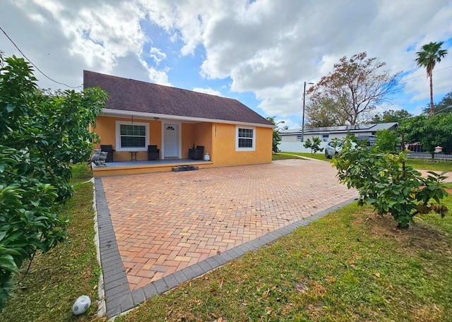 rear view of property with a porch