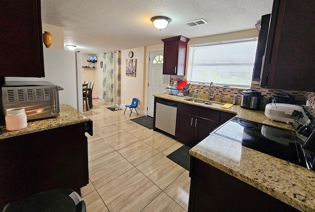 kitchen with dishwasher, sink, a textured ceiling, tasteful backsplash, and range