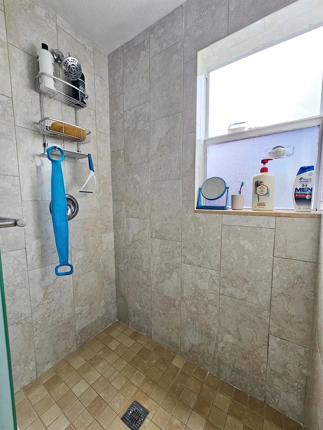 bathroom with a tile shower