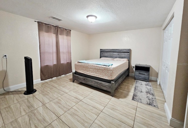 bedroom with a closet and a textured ceiling