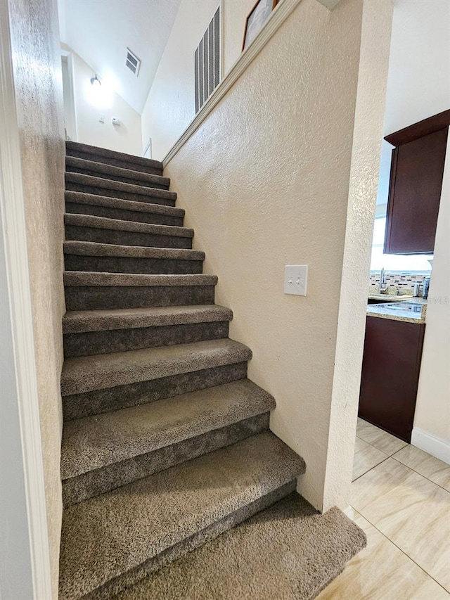 stairs with tile patterned floors