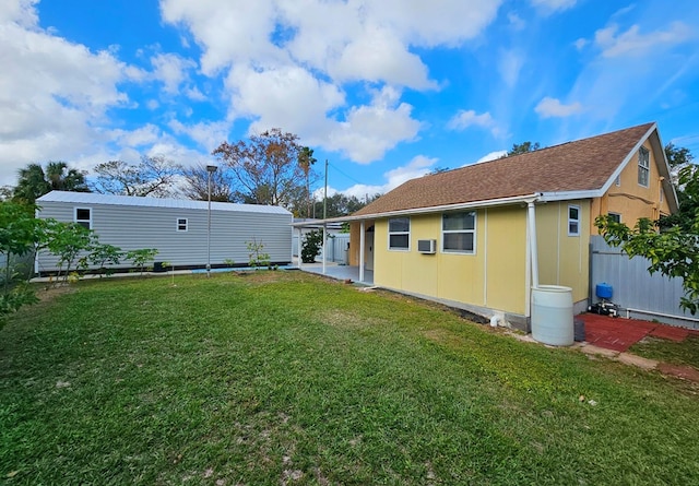 rear view of house featuring a yard