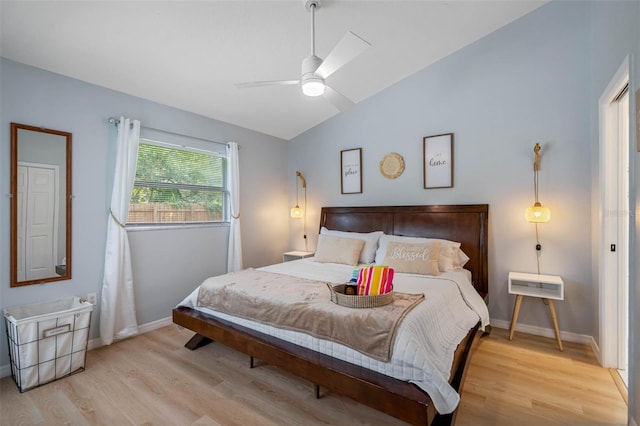 bedroom featuring ceiling fan, light hardwood / wood-style flooring, and lofted ceiling