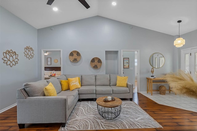 living room with high vaulted ceiling, ceiling fan, and dark wood-type flooring