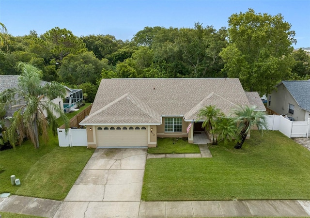 view of front of property featuring a garage and a front lawn