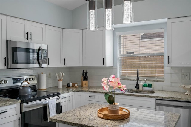 kitchen with decorative backsplash, sink, white cabinetry, and stainless steel appliances