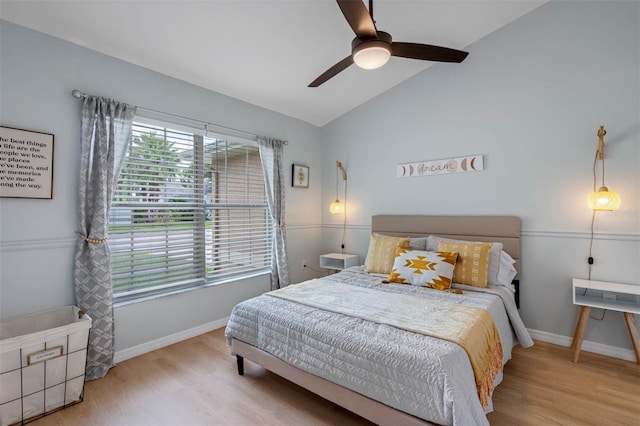 bedroom featuring ceiling fan, light hardwood / wood-style flooring, and vaulted ceiling