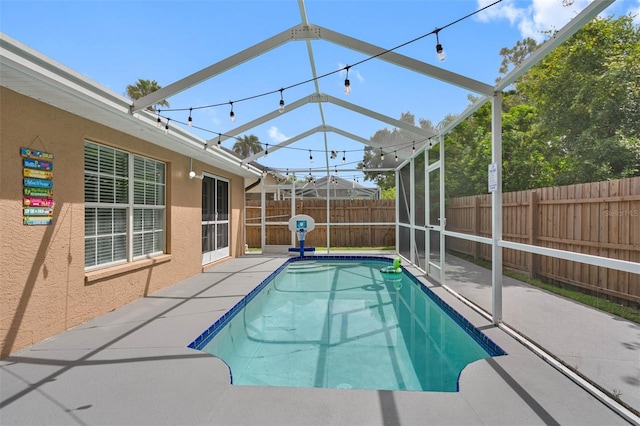 view of swimming pool with a lanai and a patio