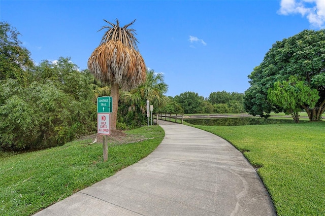 view of property's community with a lawn