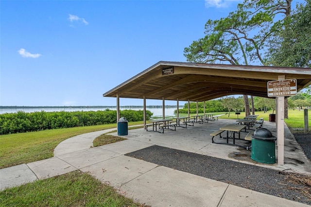 view of community featuring a lawn, a water view, a gazebo, and a patio