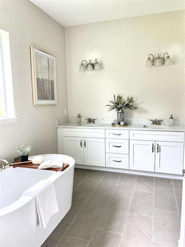 bathroom with tile patterned floors, vanity, and a bathing tub