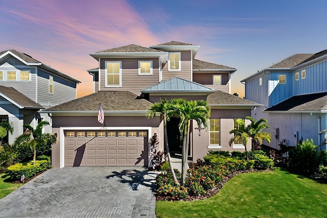 view of front facade with a lawn and a garage