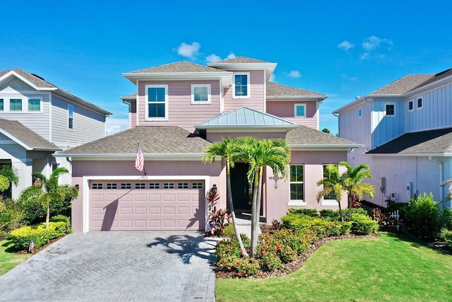 view of front of home with a front yard and a garage