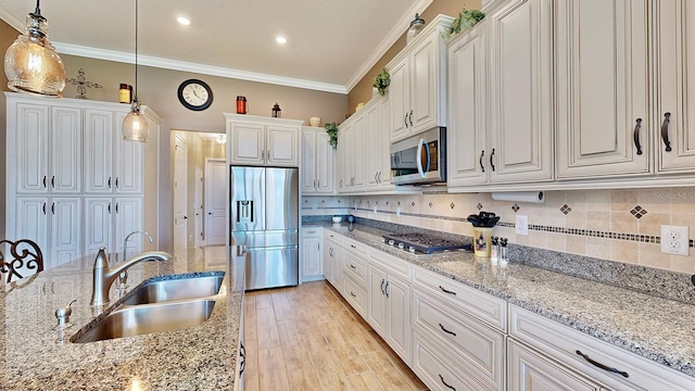 kitchen featuring pendant lighting, white cabinetry, appliances with stainless steel finishes, and tasteful backsplash