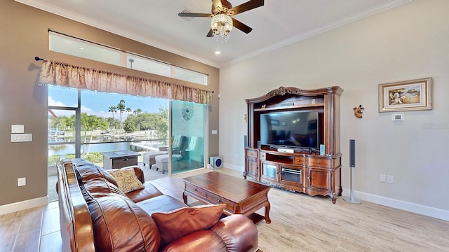 living room with ceiling fan, crown molding, a water view, and light hardwood / wood-style flooring