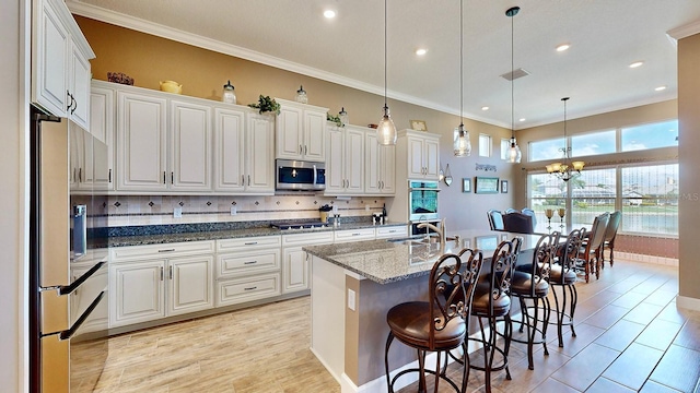 kitchen featuring dark stone counters, white cabinets, and stainless steel appliances