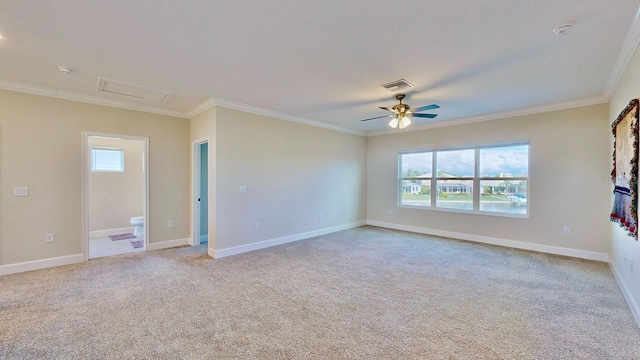 spare room featuring ceiling fan, light colored carpet, and ornamental molding