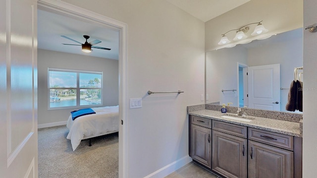 bathroom with ceiling fan, a water view, and vanity