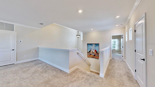 corridor with crown molding and light colored carpet