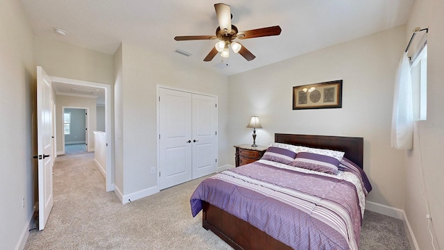 bedroom featuring a closet, ceiling fan, and light colored carpet