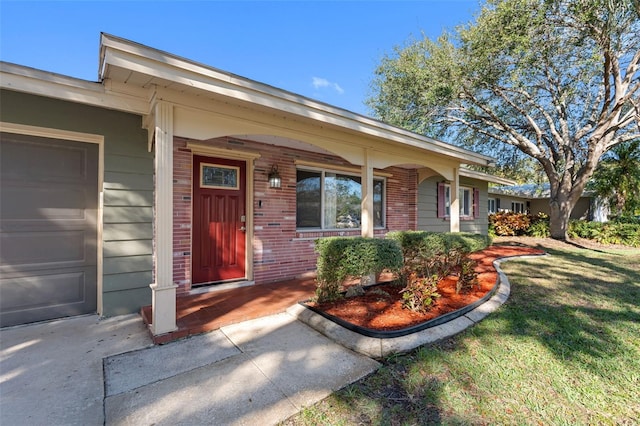 property entrance with a yard and a garage