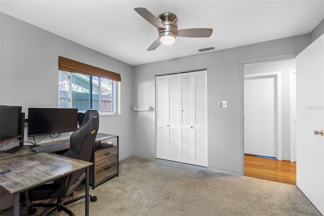 home office featuring light colored carpet and ceiling fan