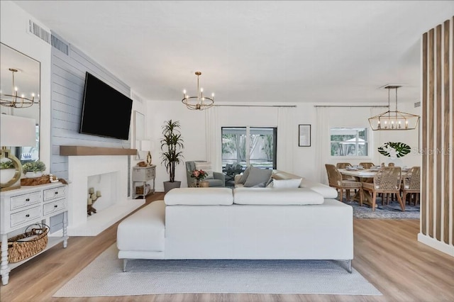 living room with a large fireplace and light hardwood / wood-style floors