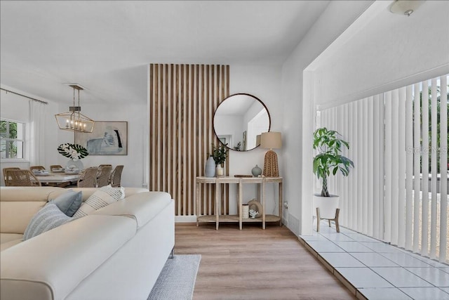 living room featuring a chandelier and light hardwood / wood-style flooring