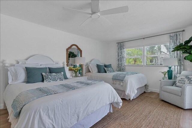 bedroom with ceiling fan and hardwood / wood-style flooring