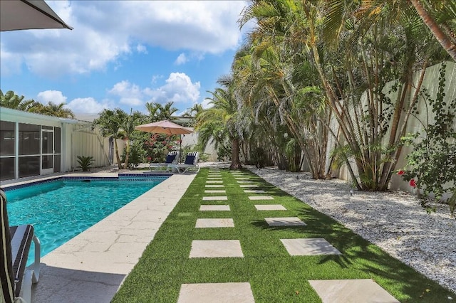 view of swimming pool with a jacuzzi