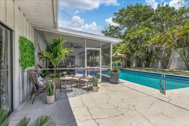 view of swimming pool featuring a patio and a sunroom