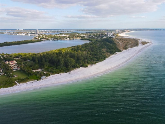 birds eye view of property featuring a beach view and a water view