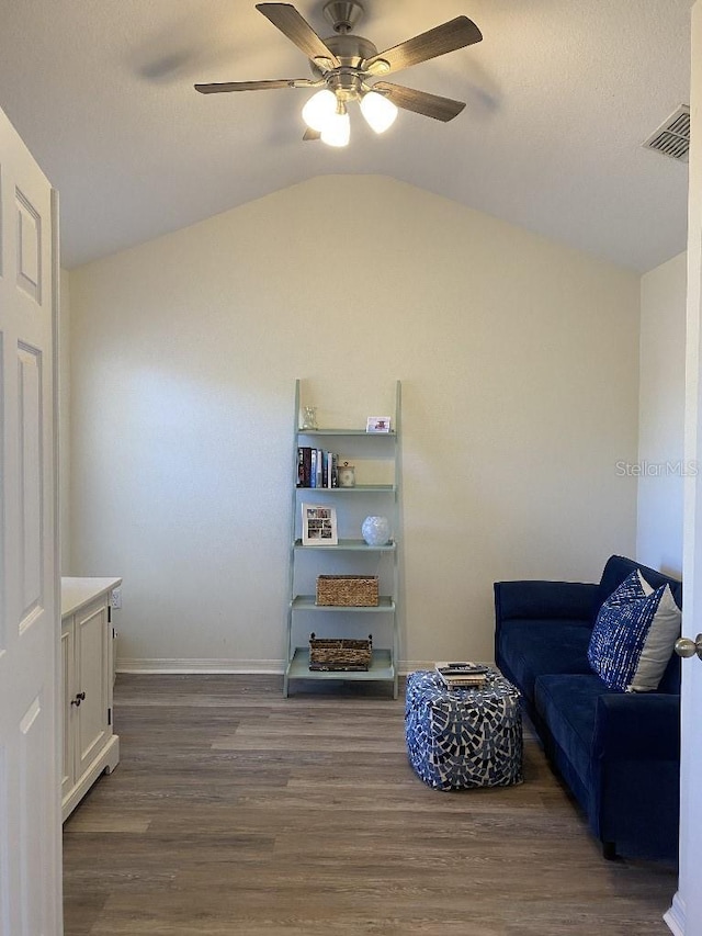 sitting room featuring dark hardwood / wood-style floors, ceiling fan, and vaulted ceiling