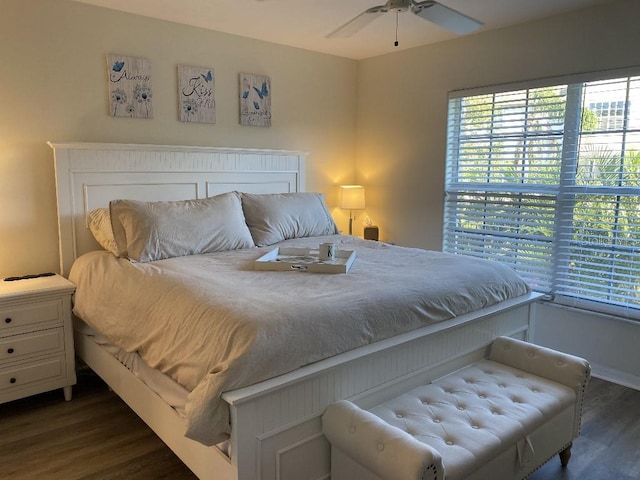 bedroom with ceiling fan and dark hardwood / wood-style flooring