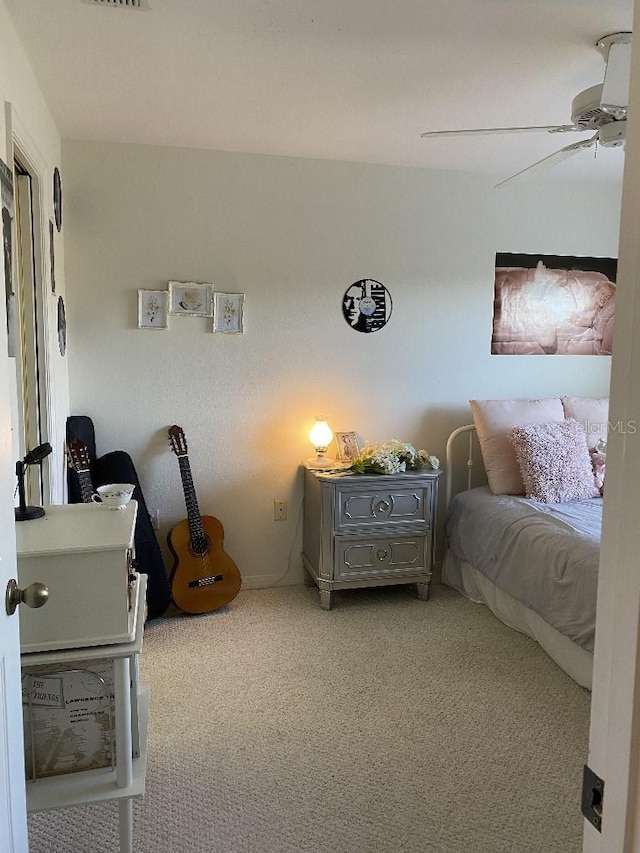 bedroom with ceiling fan and light colored carpet