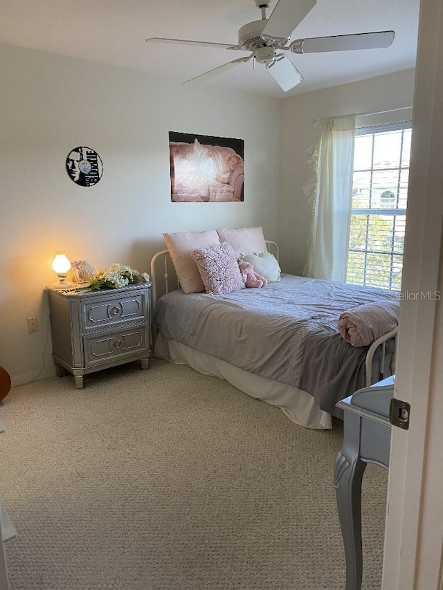 bedroom with light carpet and ceiling fan