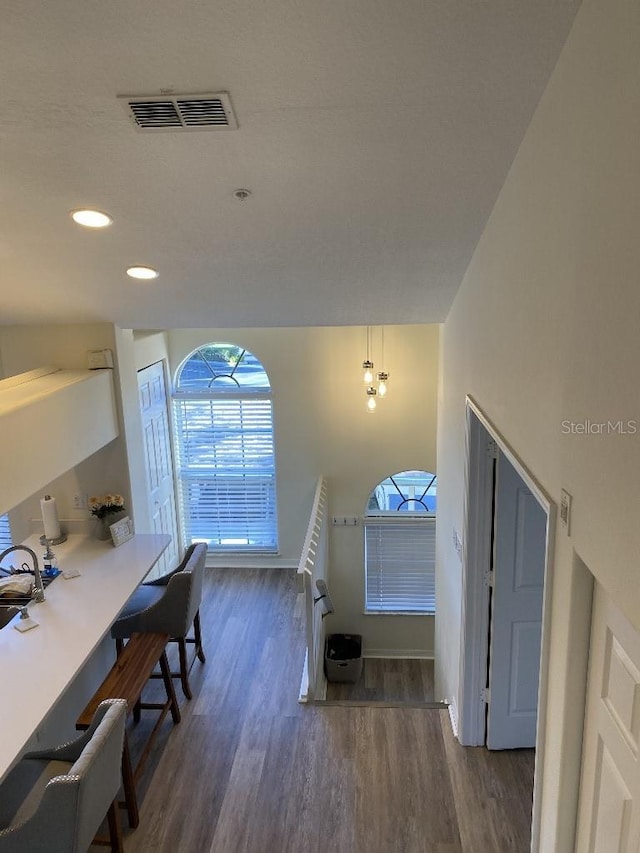 interior space featuring wood-type flooring and a notable chandelier