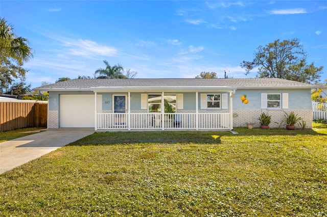 single story home featuring a garage, a front yard, and a porch