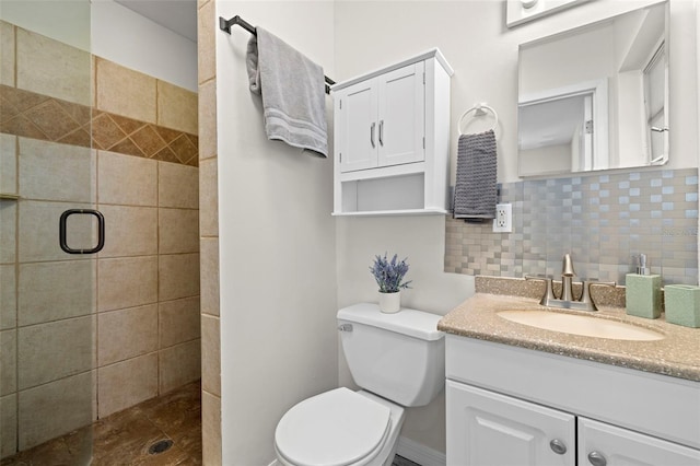 bathroom with vanity, a shower with shower door, toilet, and decorative backsplash