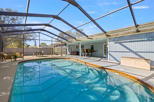 view of swimming pool with a patio area and glass enclosure