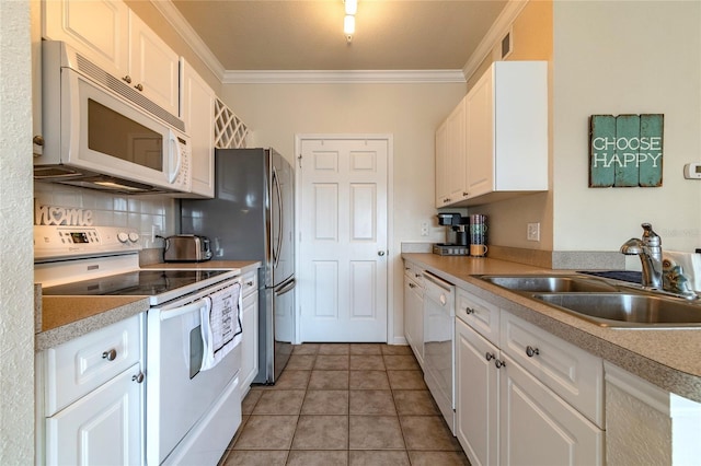 kitchen with sink, white cabinets, white appliances, and light tile patterned floors