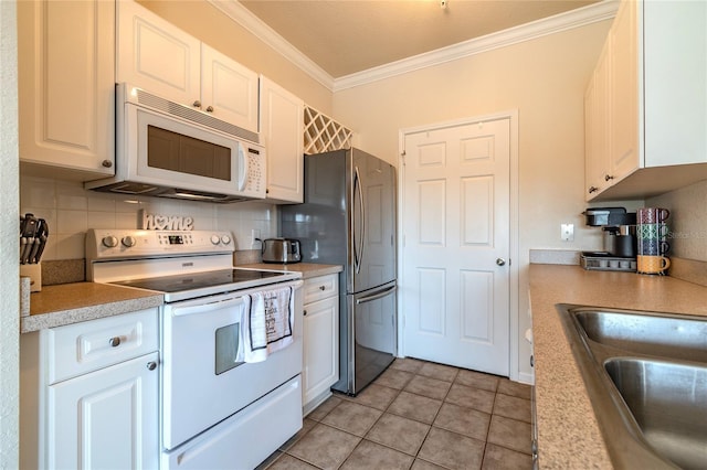 kitchen featuring white cabinets, backsplash, crown molding, white appliances, and light tile patterned floors