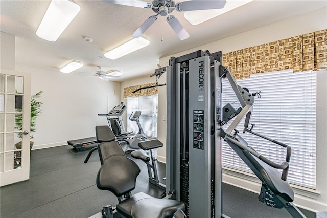 workout area featuring ceiling fan and a textured ceiling