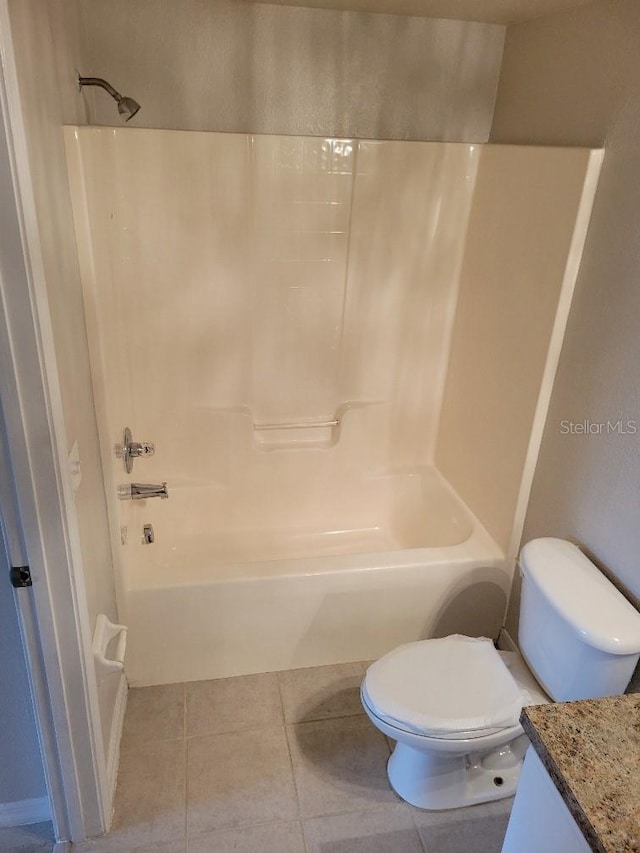 full bathroom featuring toilet, bathtub / shower combination, vanity, and tile patterned floors