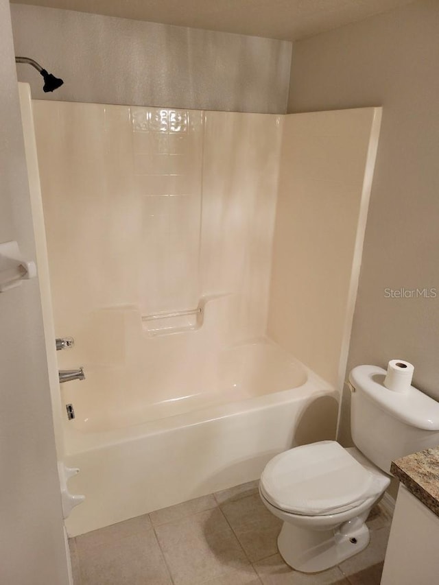 full bathroom with tile patterned flooring, vanity, toilet, and  shower combination