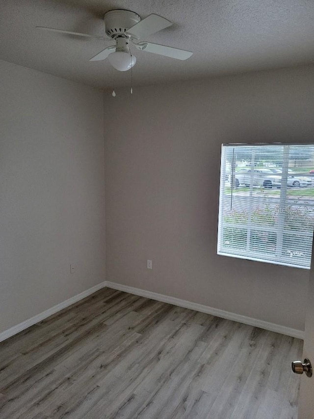 unfurnished room featuring ceiling fan and light wood-type flooring