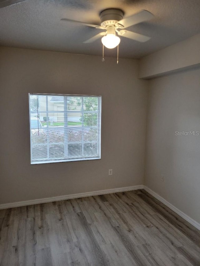 unfurnished room with ceiling fan and light wood-type flooring