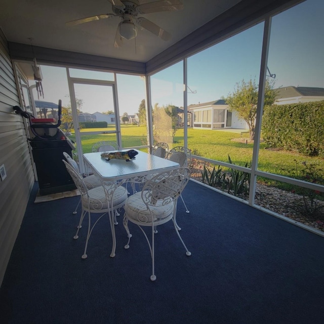 sunroom featuring ceiling fan